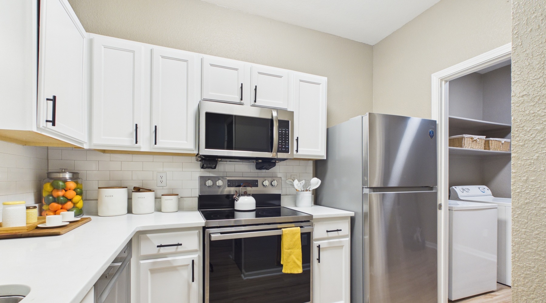 a white shelving unit with baskets