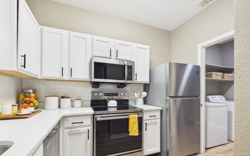 a white shelving unit with baskets